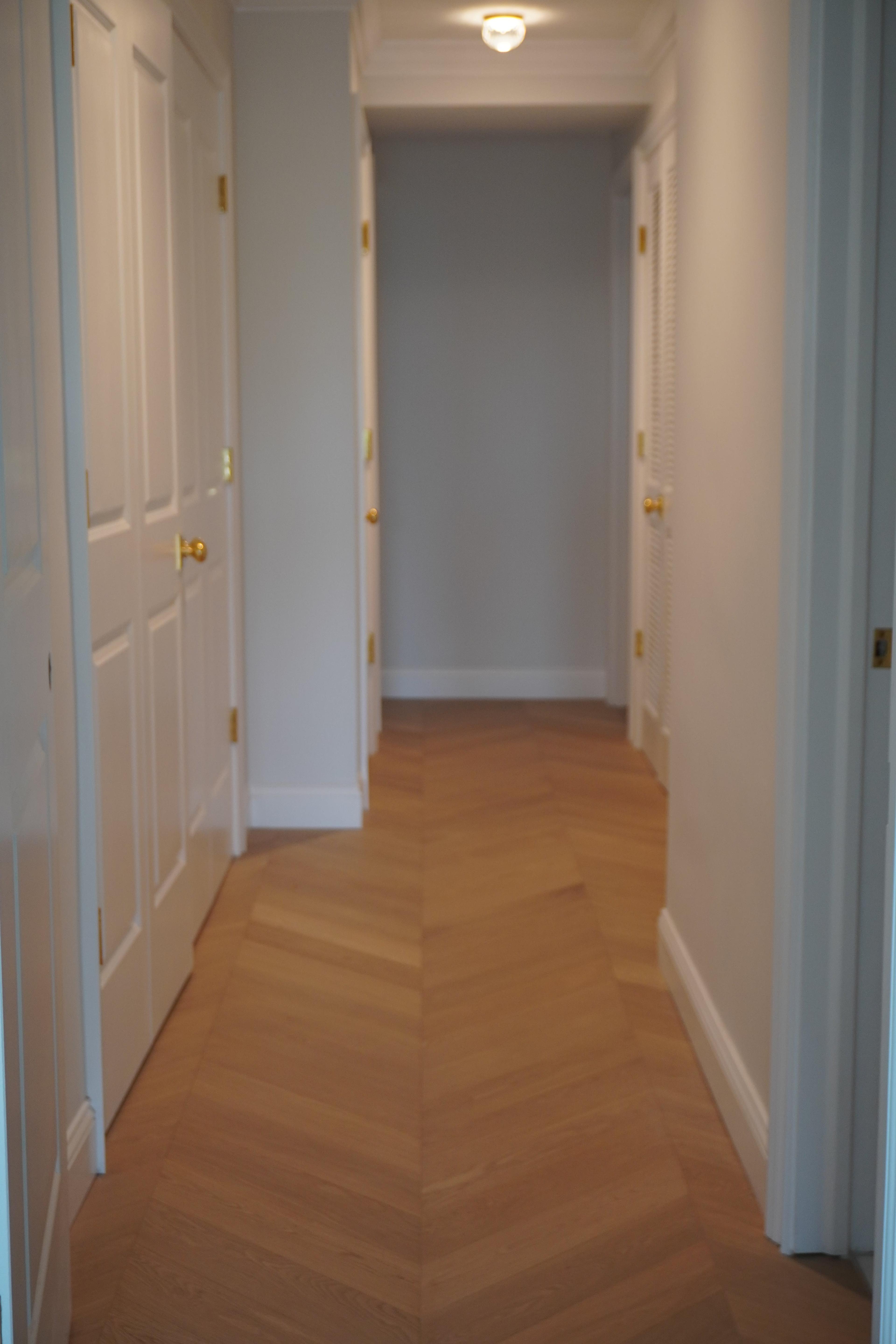 Chevron hardwood running the length of a hallway at 116 Central Park South