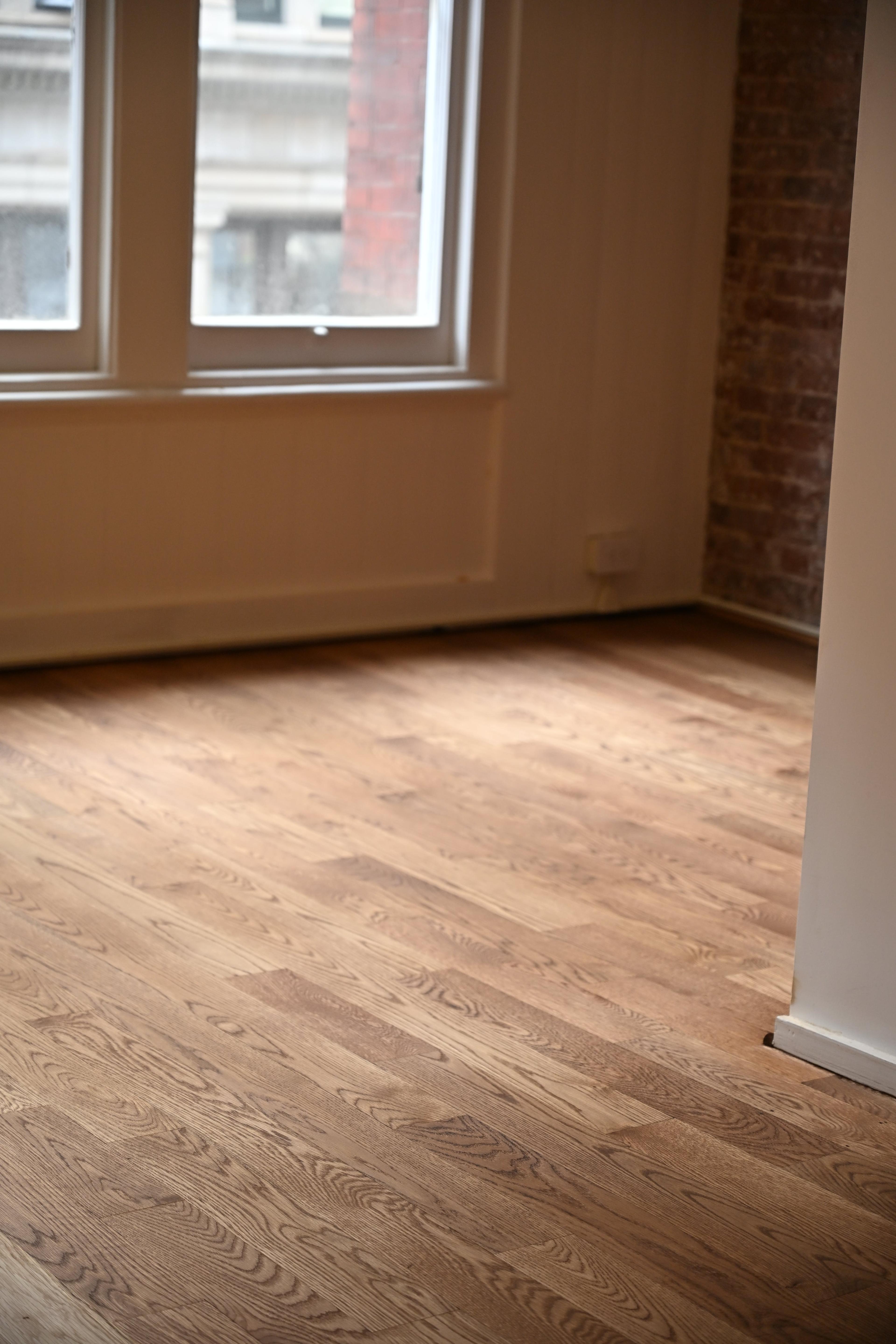 Finished hardwood floor in a loft room at 158 Franklin St