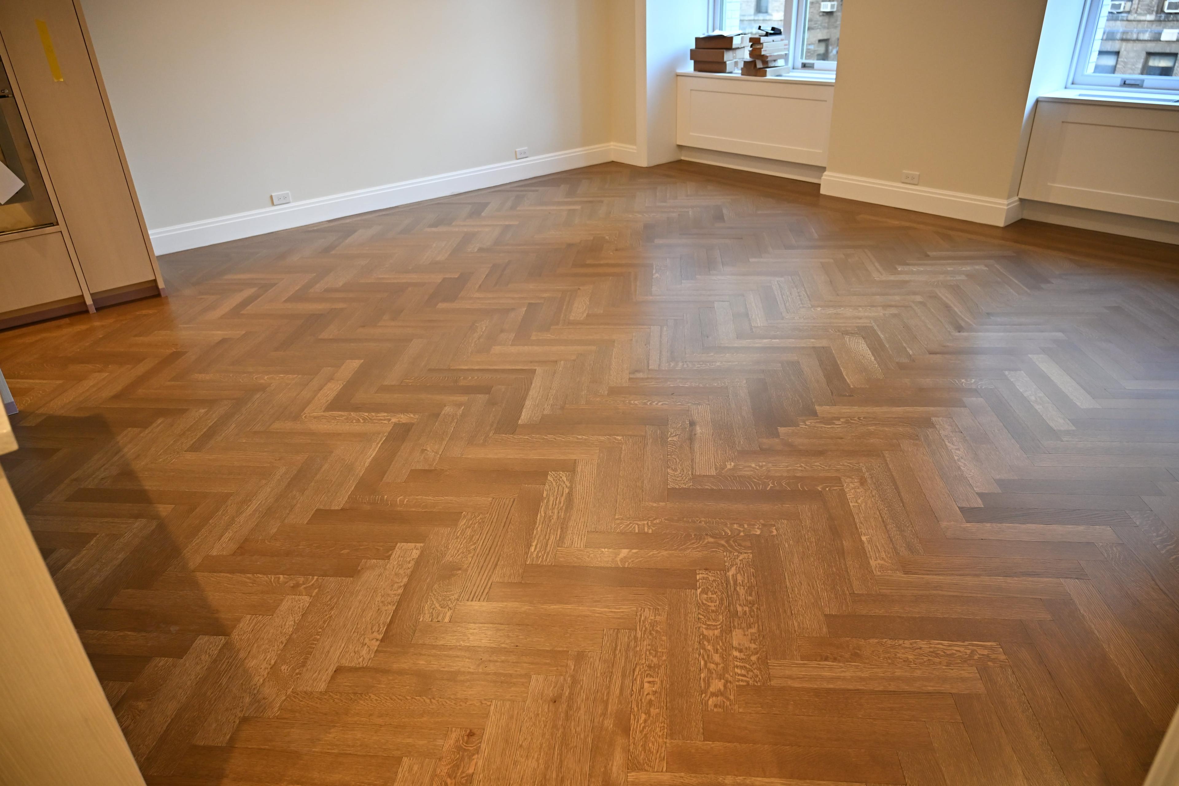 Herringbone hardwood floor in a finished room at 225 West