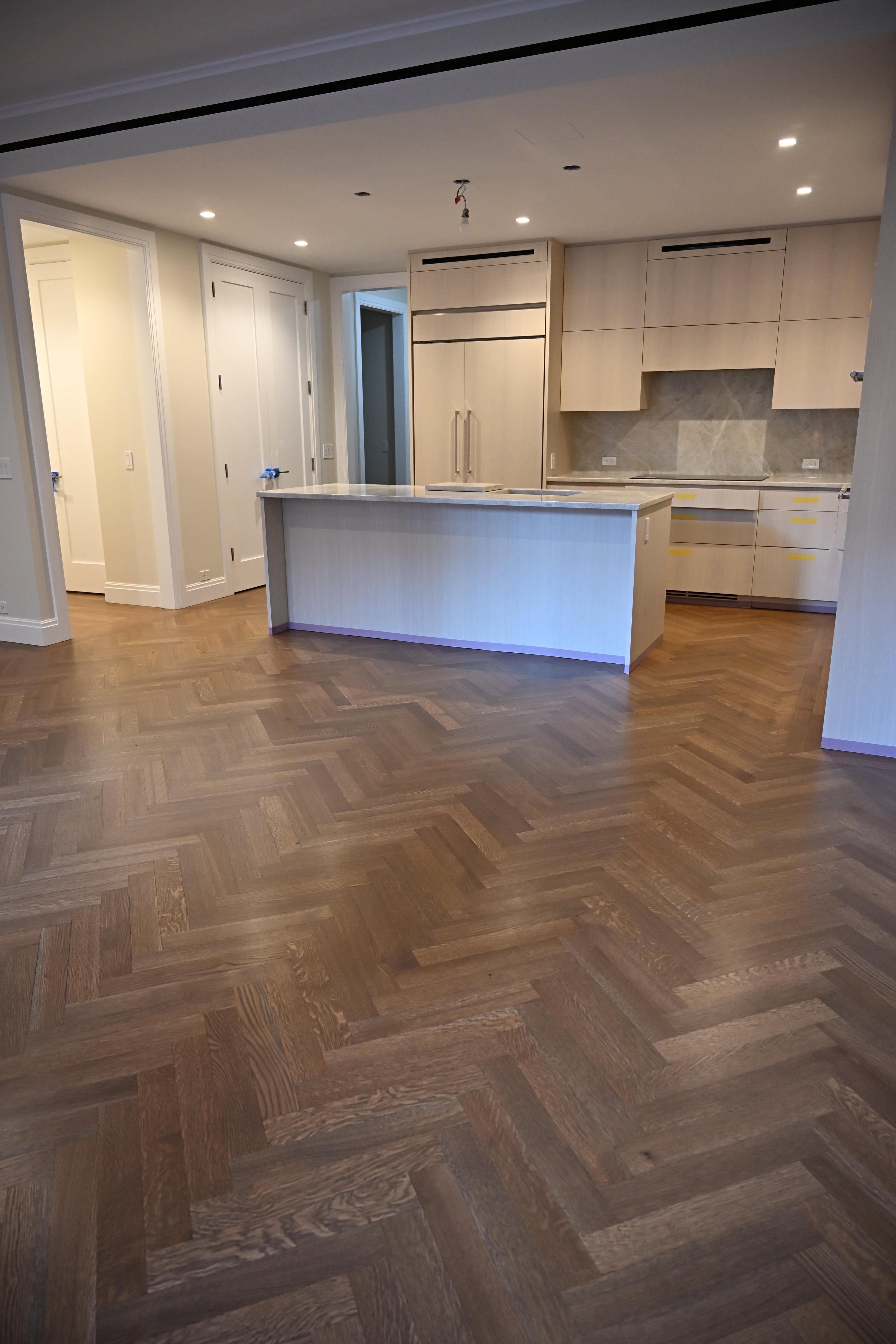 Herringbone hardwood running through the kitchen at 225 West