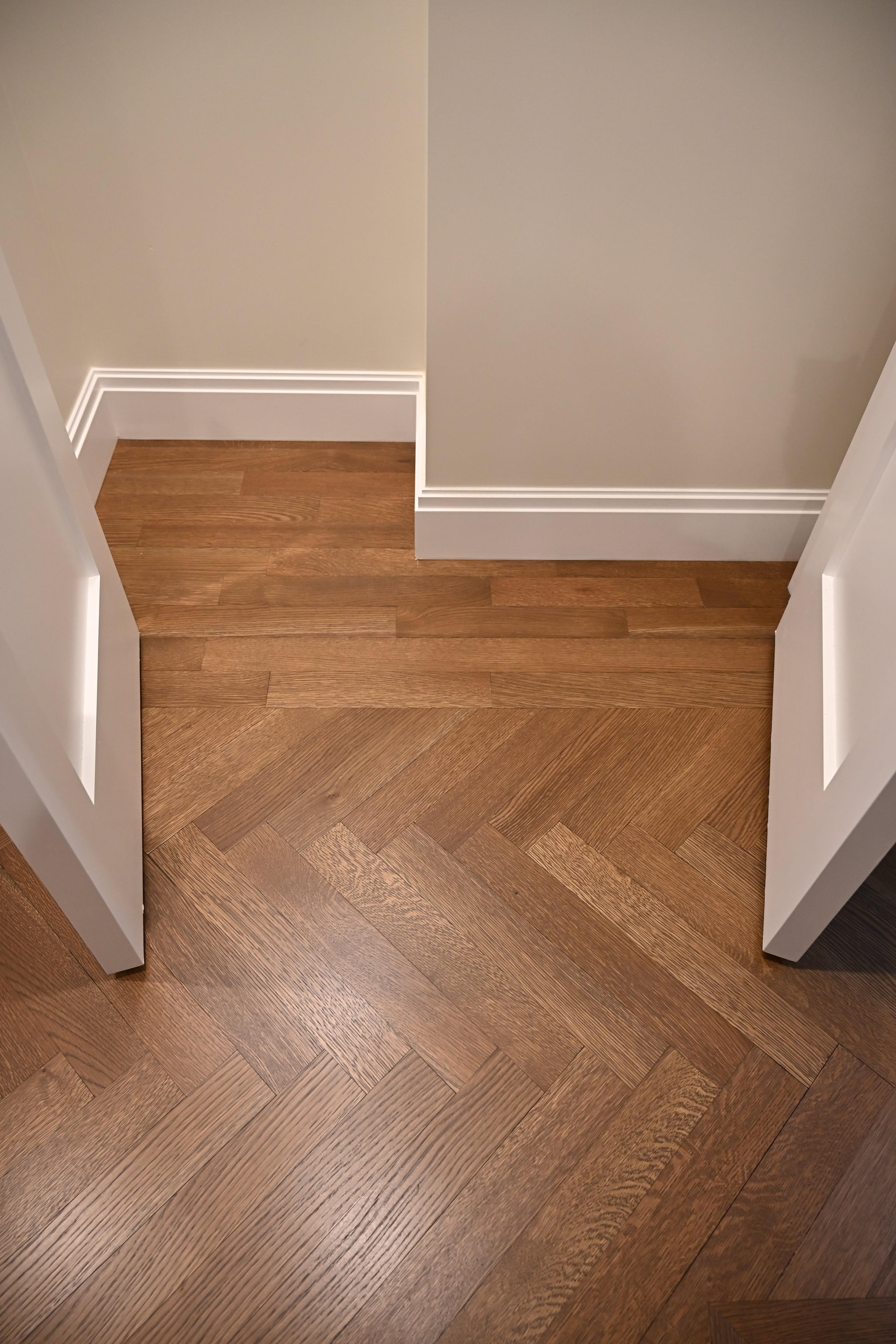 Herringbone-to-straight floor transition at 225 West