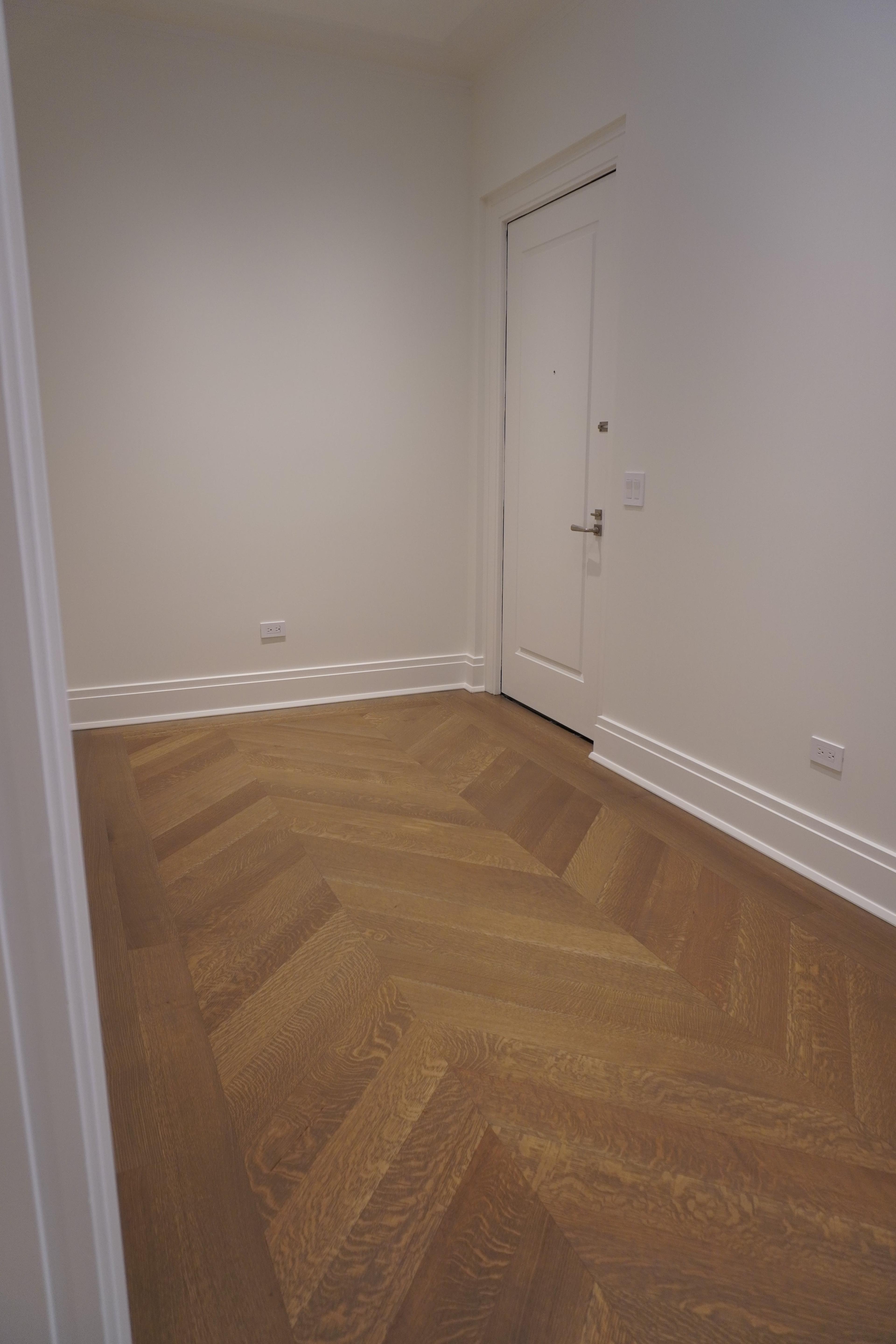 Finished chevron floor in an adjoining room at the Belnord Apartment Upper West