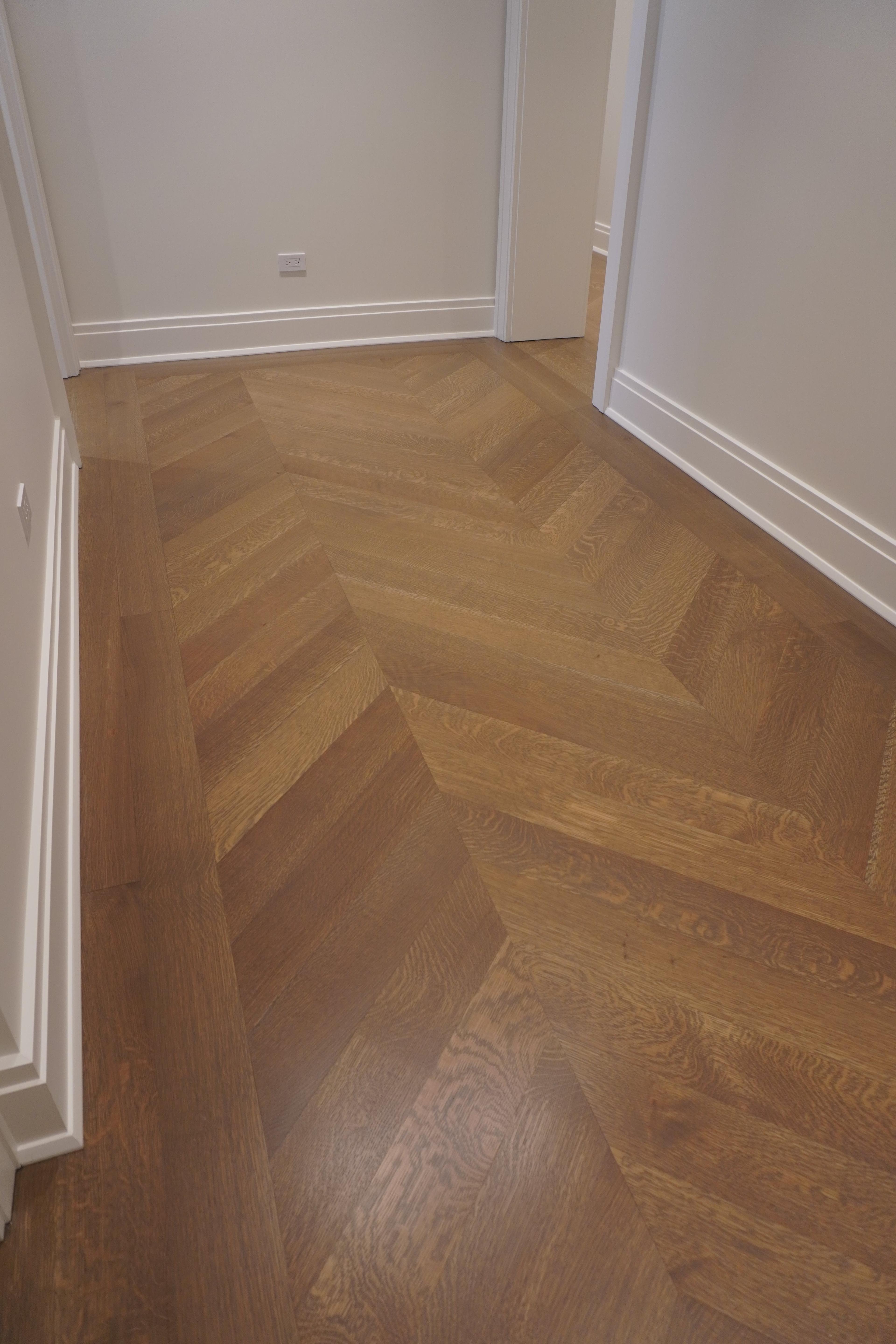 Chevron floor with a straight-laid border at the Belnord Apartment Upper West