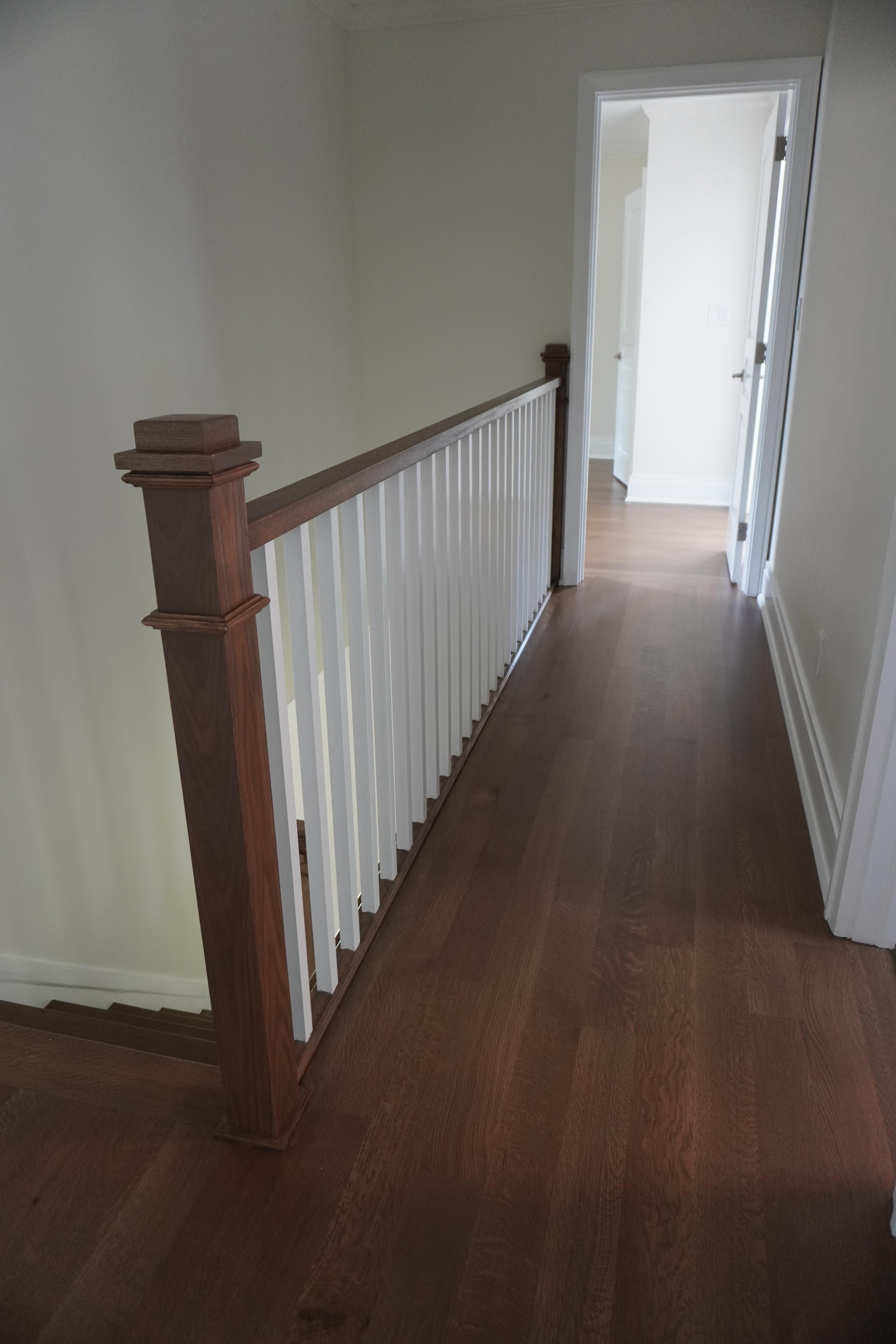 Wide-plank hardwood on the landing at Twix hills Rd