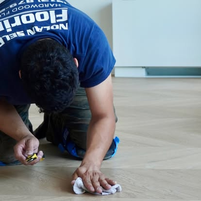 Nolan crew finishing a patterned hardwood floor
